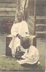 Two boys, one examining the other's feet, Sierra Leone